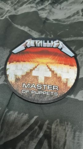 Кръгла текстилна нашивка Metallica Master of Puppets с бели кръстове и оранжево небе.