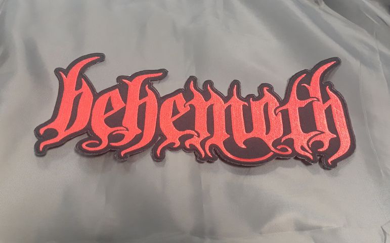 Голяма бродирана нашивка Behemoth с червено лого върху тъмносив фон.