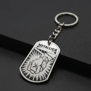 Стоманен ключодържател Metallica St. Anger с гравиран юмрук и лого на черен фон.
