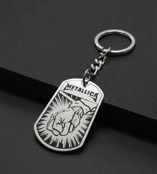 Стоманен ключодържател Metallica St. Anger с гравиран юмрук и лого на черен фон.