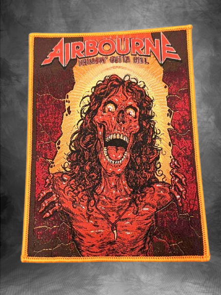 Нашивка с обложката на албума Airbourne "Breakin' Outta Hell", изобразяваща свиреп, горящ звяр с червена коса